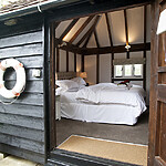 Michael Edwards stays at Old Luxters Farmhouse, sipping wine poolside, possibly England’s most luxurious “shed.”