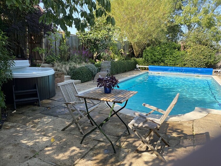 Michael Edwards stays at Old Luxters Farmhouse, sipping wine poolside, possibly England’s most luxurious “shed.”