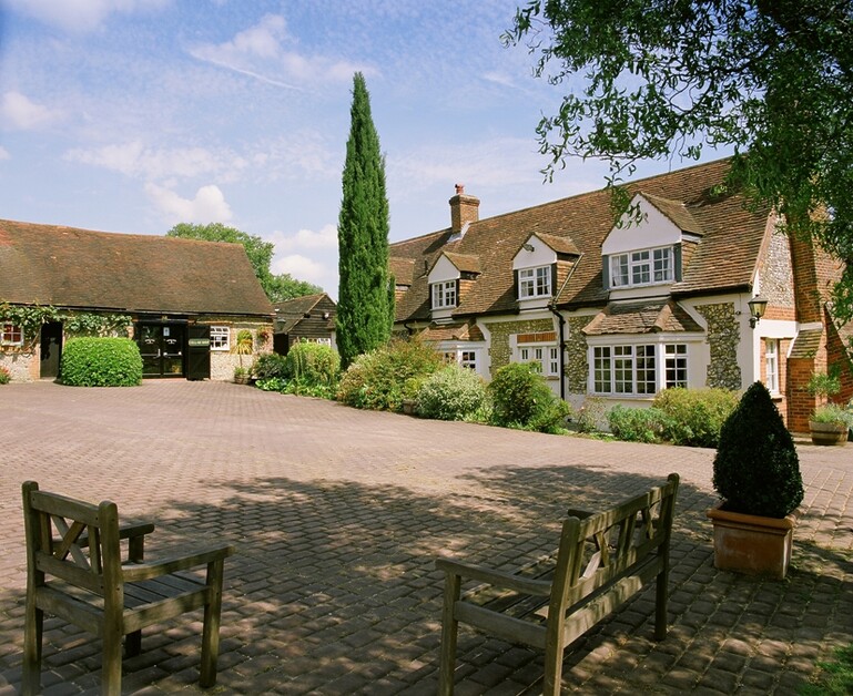 Michael Edwards stays at Old Luxters Farmhouse, sipping wine poolside, possibly England’s most luxurious “shed.”